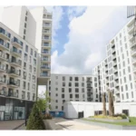 Apartment building courtyard with landscaped greenery and modern flats at Cardinal Place, Woking