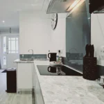 Kitchen view showing counter, modern lighting, and appliances at The Oak Suite, Farnham