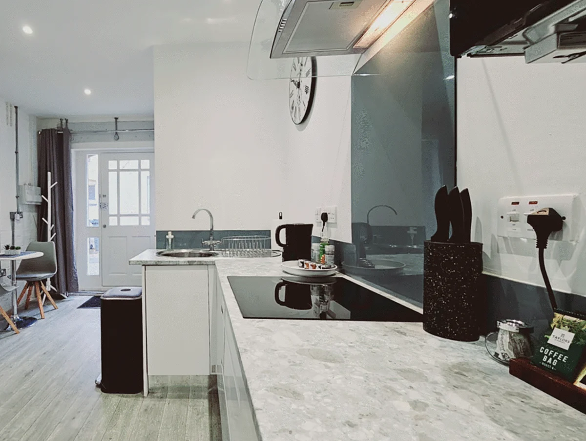 Kitchen view showing counter, modern lighting, and appliances at The Oak Suite, Farnham