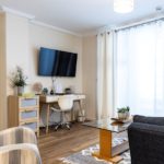 Living area with TV, sofa, and wide windows, The Elm Suite, Kings Road, Reading