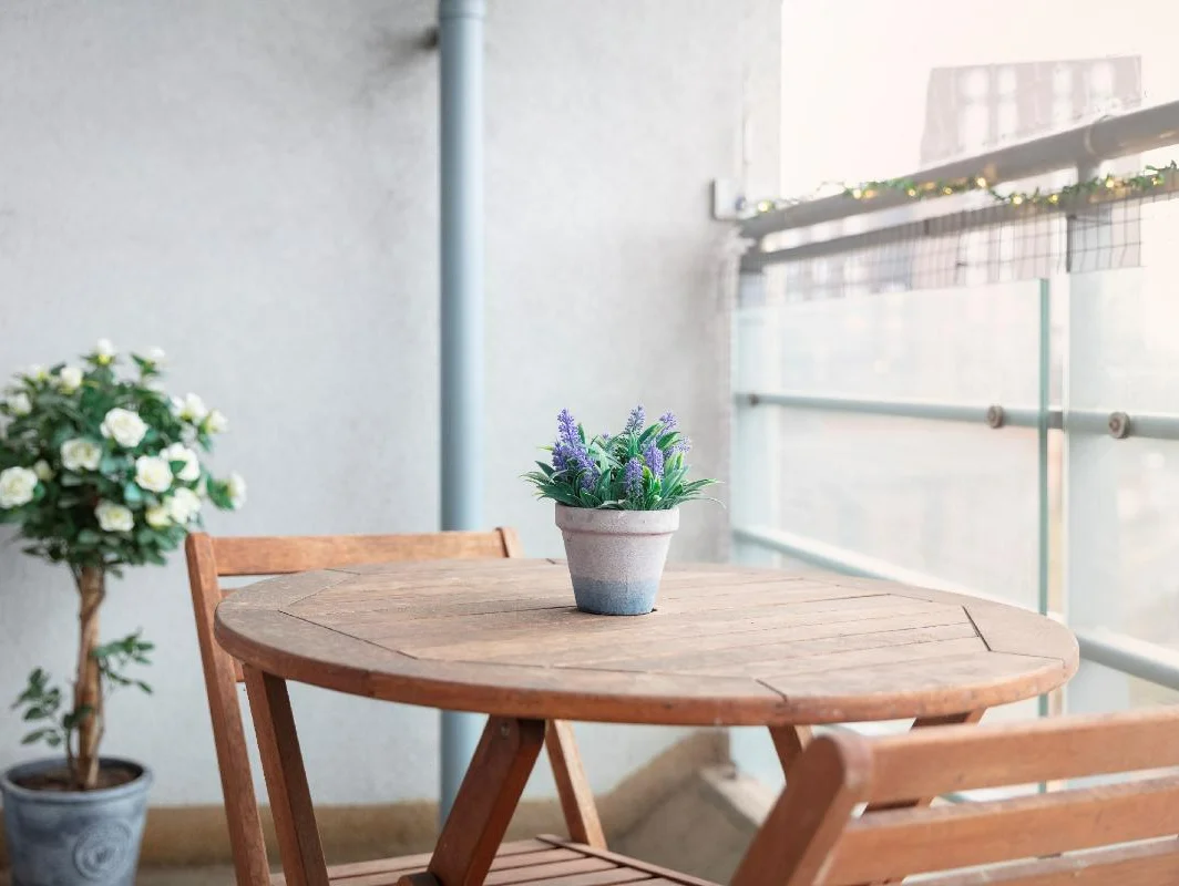 Private balcony with potted plants and wooden table at The Elm Suite, Kings Road, Reading
