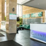 Reception area with Centrium signage and seating at modern apartment complex, Woking
