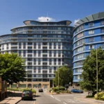 Street view of Centrium apartment complex with curved modern architecture, Woking