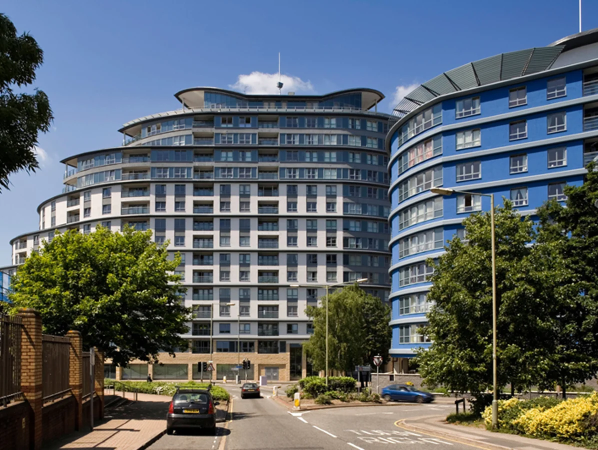 Street view of Centrium apartment complex with curved modern architecture, Woking