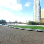 Sunny courtyard with landscaped pathways and garden at Kings Road apartments, Reading