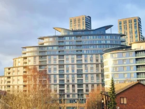Bright twin bedroom with large windows, modern lamps, and city views at The Daisy Suite, Centrium, Woking