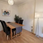 Dining area with wooden furniture and indoor plant at The Daisy Suite, Centrium, Woking