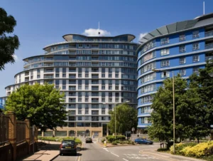 Bright twin bedroom with large windows, modern lamps, and city views at The Daisy Suite, Centrium, Woking