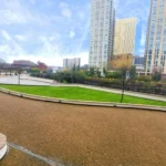View of landscaped courtyard and green gardens surrounded by Centrium apartment Blocks, Woking