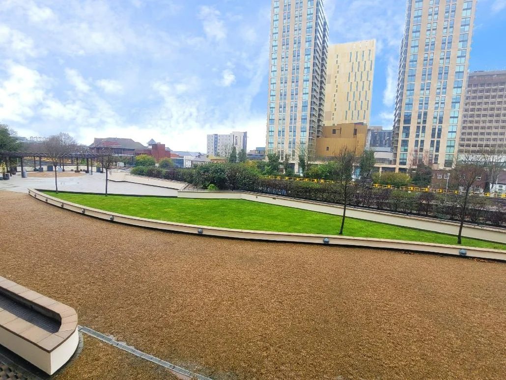 View of landscaped courtyard and green gardens surrounded by Centrium apartment Blocks, Woking