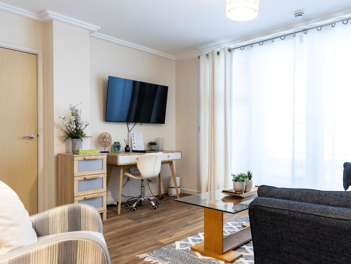 Living area with TV, sofa, and wide windows, The Elm Suite, Kings Road, Reading